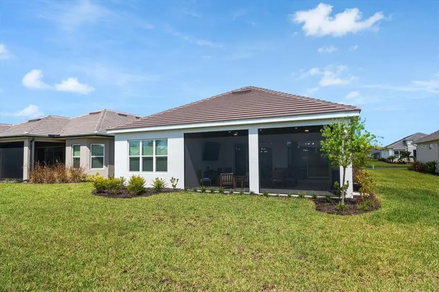 Exterior details and patio area of a home in Esplanade at Artisan Lakes, Palmetto (Image 4).