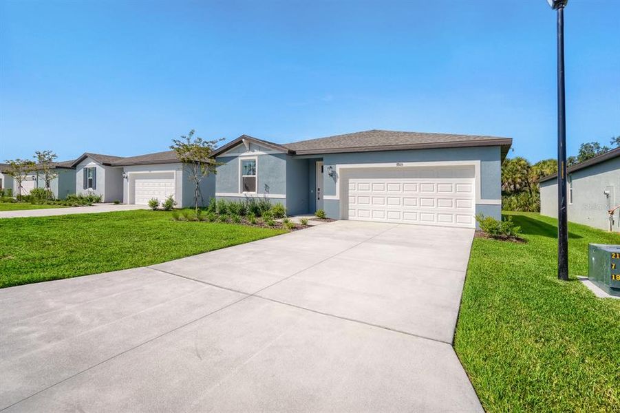 Front exterior of a new home in Salt Meadows - Classic Series, Parrish, FL, highlighting curb appeal (Image 2). Front exterior of a new home in Salt Meadows - Classic Series, Parrish, FL, highlighting curb appeal (Image 2).