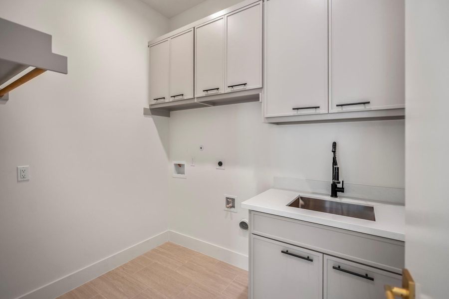 Beautiful laundry room with sink and soft close cabinets provide a more luxurious experience that makes everyday chores something to look forward to. Beautiful laundry room with sink and soft close cabinets provide a more luxurious experience that makes everyday chores something to look forward to.