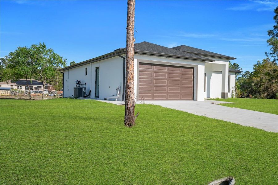 Front exterior of a new home in , Lehigh Acres, FL, highlighting curb appeal (Image 26).
