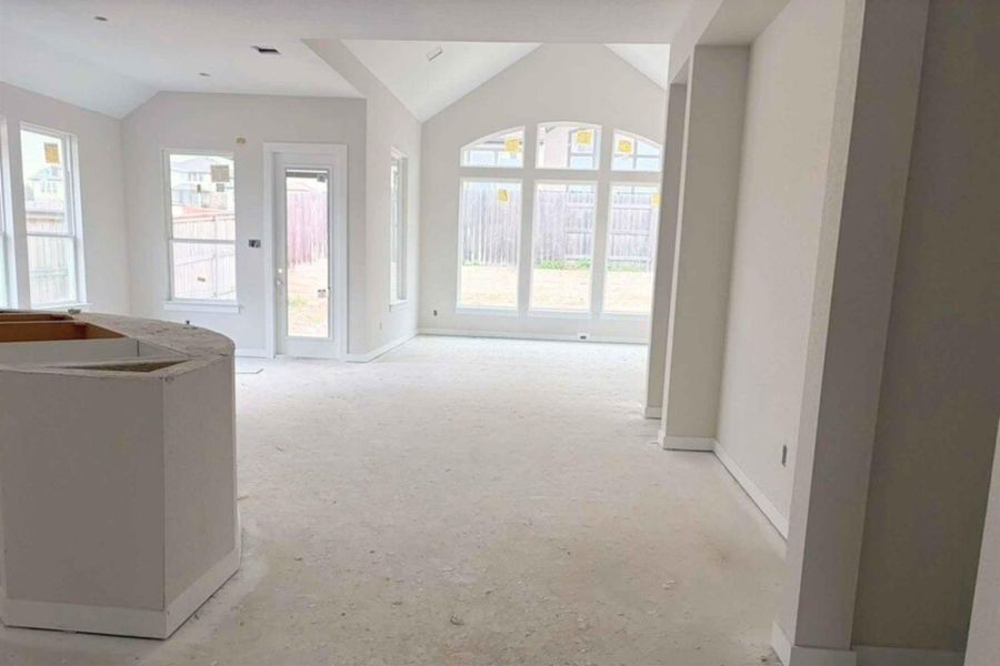 Hallway featuring vaulted ceiling and plenty of natural light