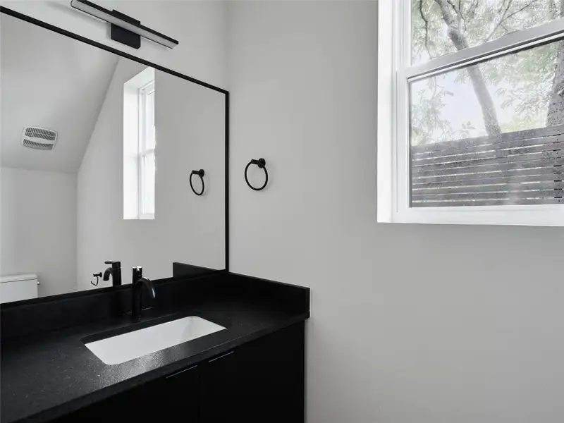 Bathroom with vanity and lofted ceiling Bathroom with vanity and lofted ceiling