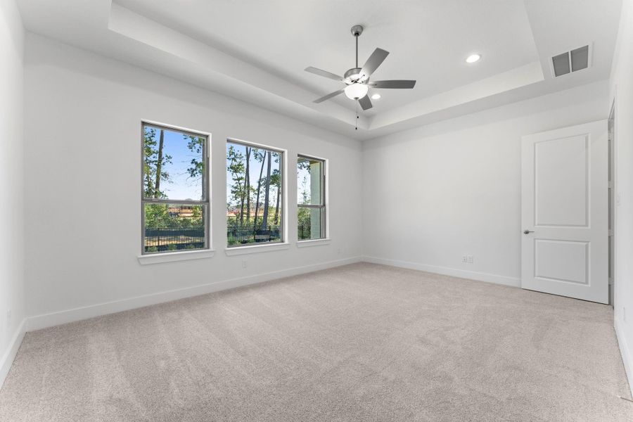 Primary bedroom suite with coffered ceiling. Primary bedroom suite with coffered ceiling.