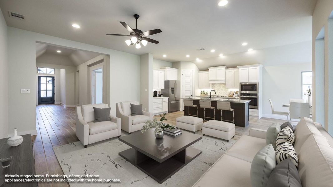 Living room featuring lofted ceiling, baseboards, ceiling fan, recessed lighting, and light wood-type flooring Living room featuring lofted ceiling, baseboards, ceiling fan, recessed lighting, and light wood-type flooring