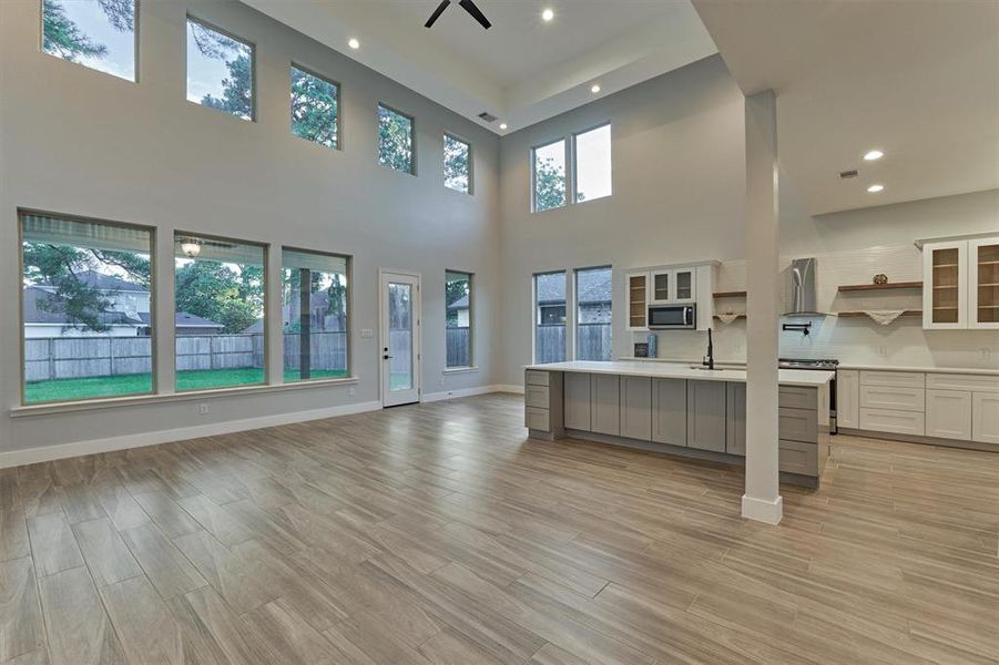 Kitchen and dining area are open to the living room. The two story space is filled with natural light from the windows above.