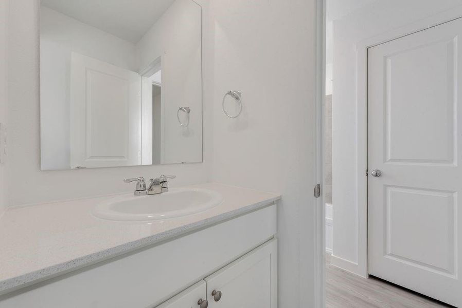 Bathroom with vanity and wood finished floors Bathroom with vanity and wood finished floors