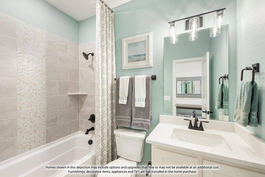 Bathroom with tiled tub-shower combo, white vanity with quartz countertop, and mint green walls