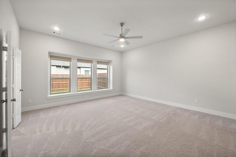 primary bedroom with window seat and custom electric woven wood window shades primary bedroom with window seat and custom electric woven wood window shades
