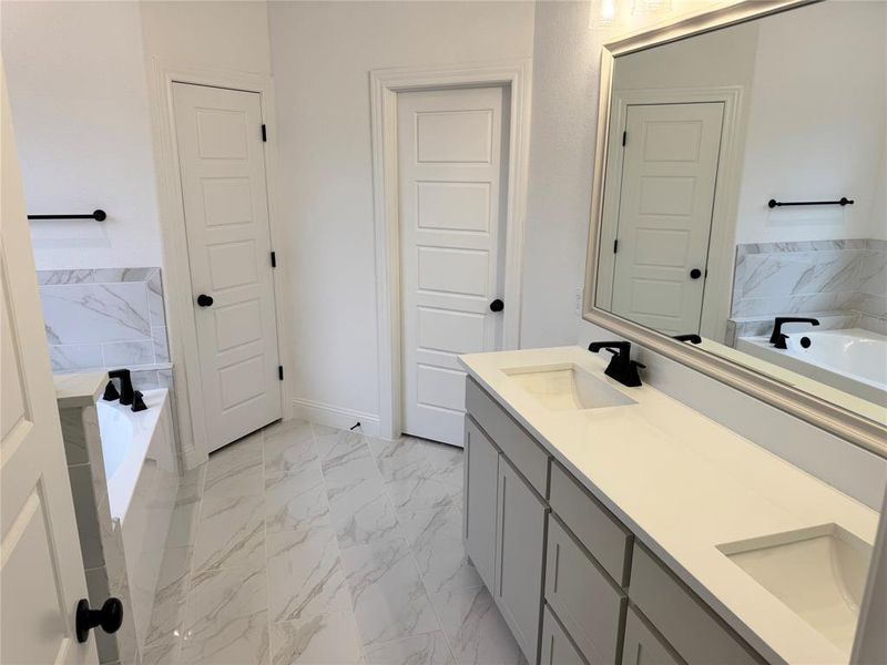 Bathroom featuring vanity and a tub