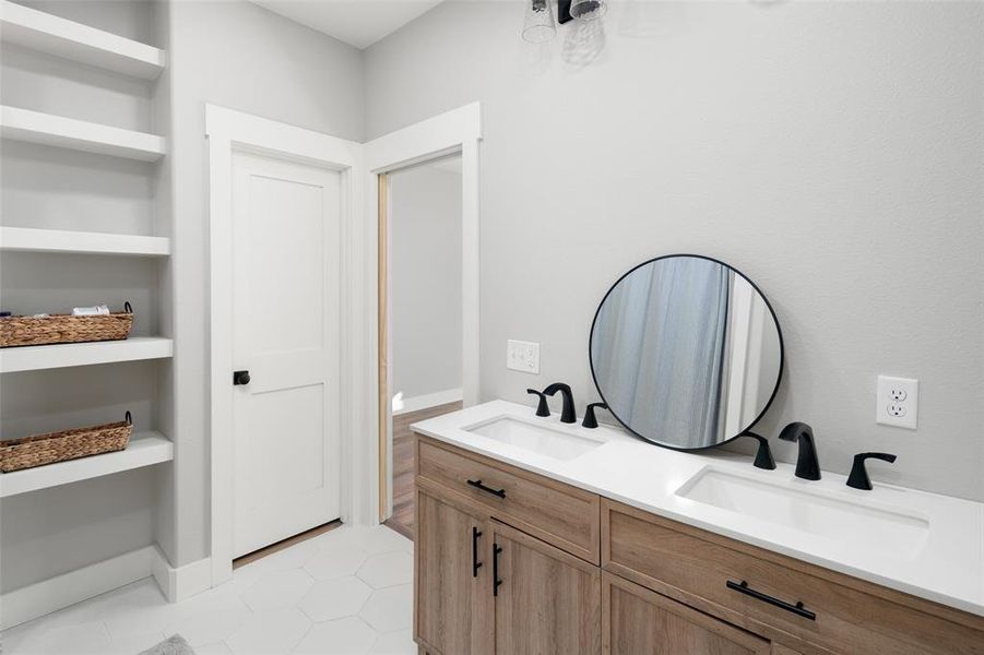 Bathroom featuring tile patterned flooring and vanity