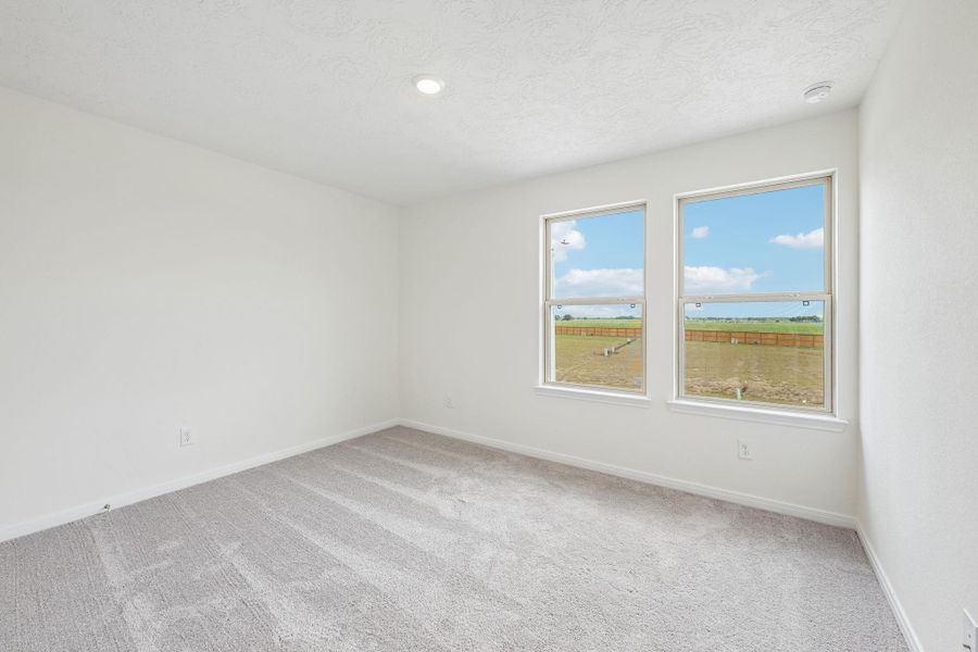 Well appointed secondary bedroom that features plush carpeting, neutral paint tones, recessed lighting, large windows, and a generously sized closet. Well appointed secondary bedroom that features plush carpeting, neutral paint tones, recessed lighting, large windows, and a generously sized closet.