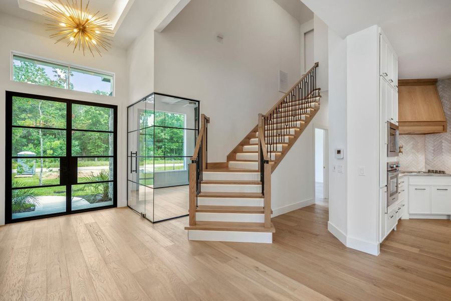 Beautiful Entry way that leads to the home office and secondary bedrooms. The gorgeous stairs have wrought iron and wood railings with accent lighting on each step leads to the massive media room and full wet bar. Beautiful Entry way that leads to the home office and secondary bedrooms. The gorgeous stairs have wrought iron and wood railings with accent lighting on each step leads to the massive media room and full wet bar.