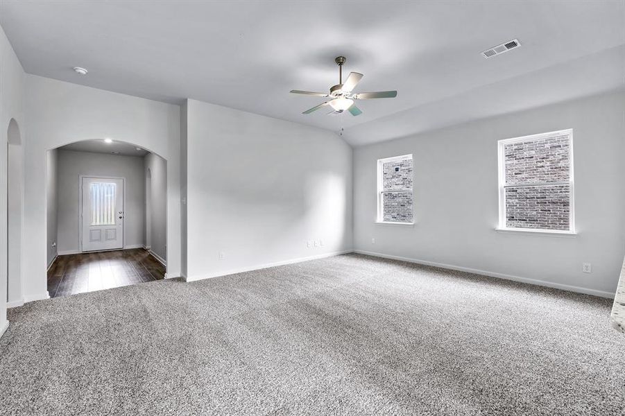 Carpeted spare room with ceiling fan