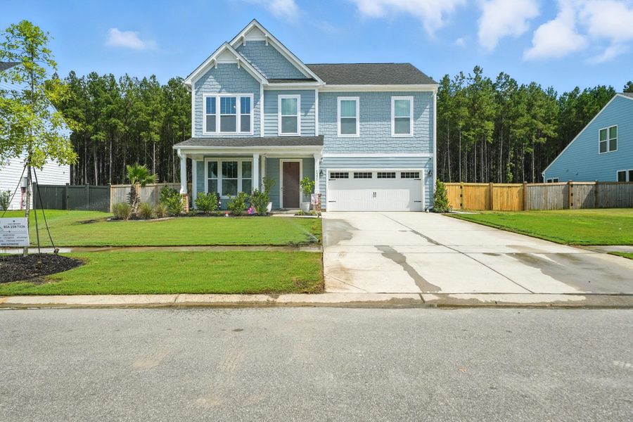 Front exterior of a new home in , Ravenel, SC, highlighting curb appeal (Image 1).