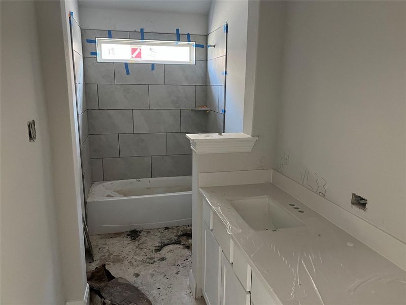 Bathroom with vanity and bathtub / shower combination