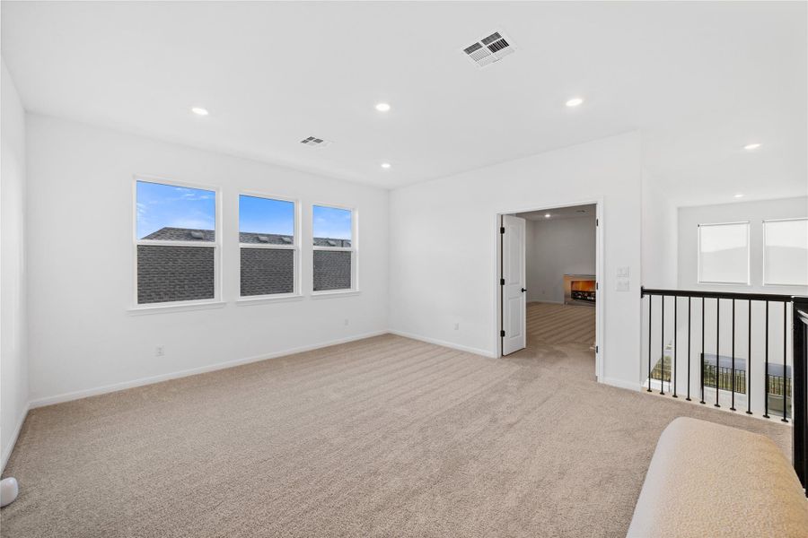 Spare room featuring light carpet and recessed lighting