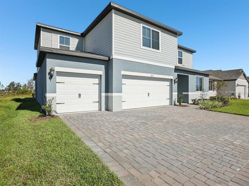 Front exterior of a new home in Two Rivers - Signature Series, Zephyrhills, FL, highlighting curb appeal (Image 1).