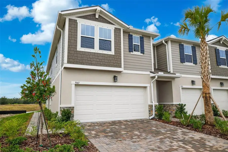 Front exterior of a new home in Crosswind Ranch, Parrish, FL, highlighting curb appeal (Image 20).