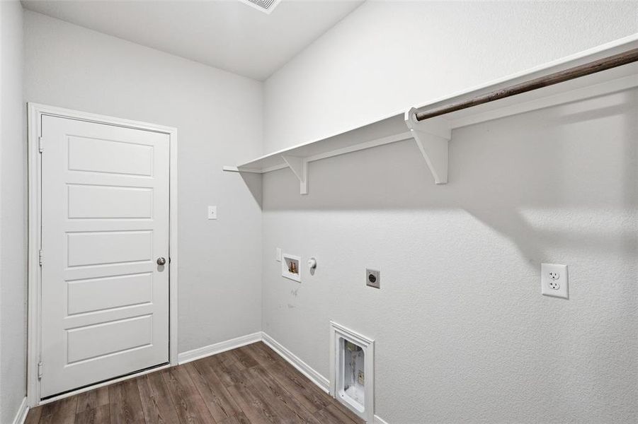 Laundry room featuring hookup for a gas dryer, hookup for an electric dryer, dark wood-style flooring, and hookup for a washing machine