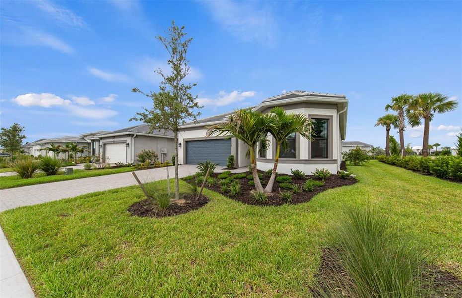 Front exterior of a new home in Del Webb Catalina, Lakewood Ranch, FL, highlighting curb appeal (Image 21). Front exterior of a new home in Del Webb Catalina, Lakewood Ranch, FL, highlighting curb appeal (Image 21).
