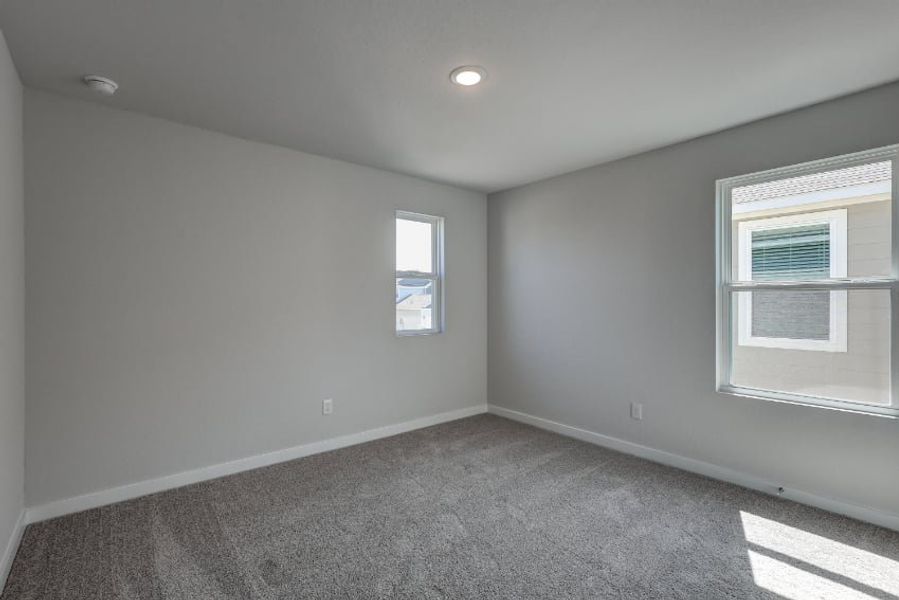 A room with windows and carpet. A room with windows and carpet.