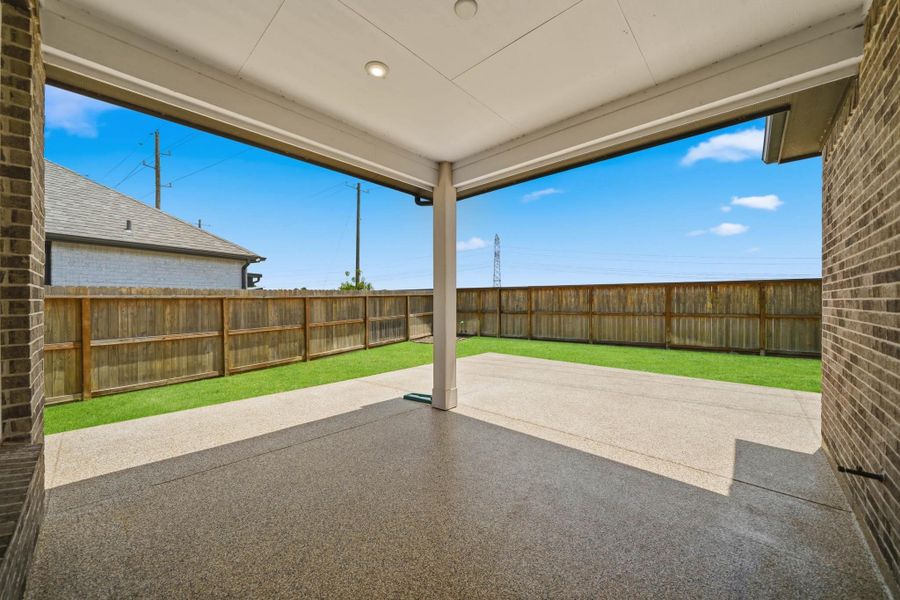Covered patio with epoxy finish offers a low maintenance outdoor retreat. Covered patio with epoxy finish offers a low maintenance outdoor retreat.