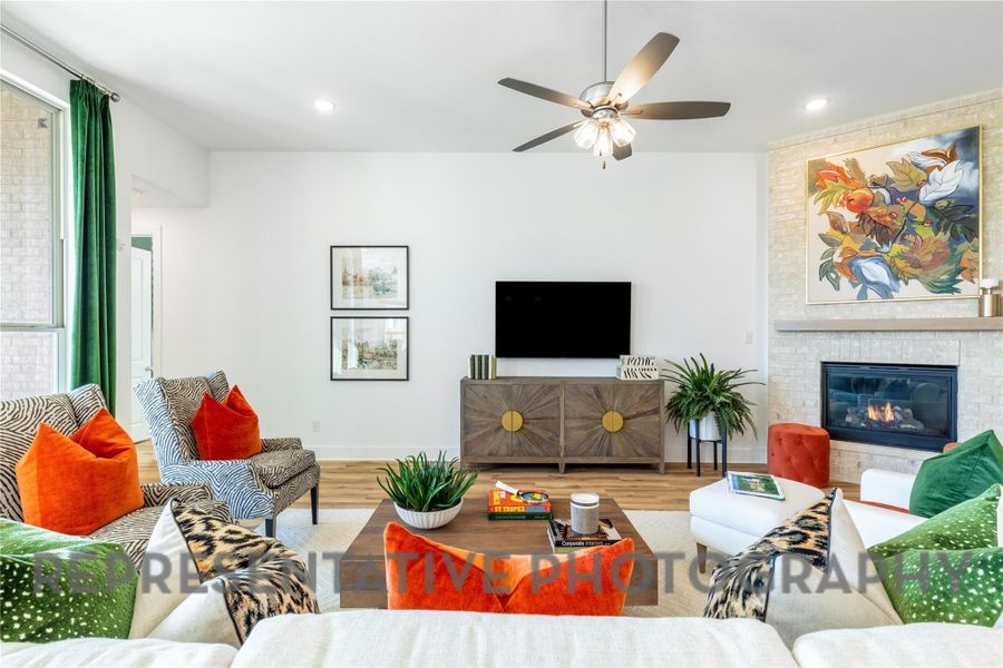 Living room with baseboards, recessed lighting, ceiling fan, and wood finished floors Living room with baseboards, recessed lighting, ceiling fan, and wood finished floors