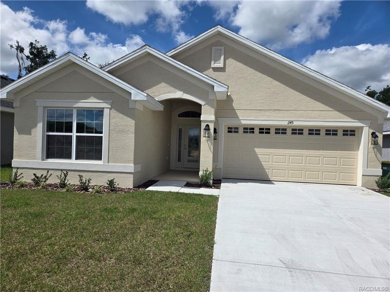 Front exterior of a new home in Wyld Palms, Inverness, FL, highlighting curb appeal (Image 1).