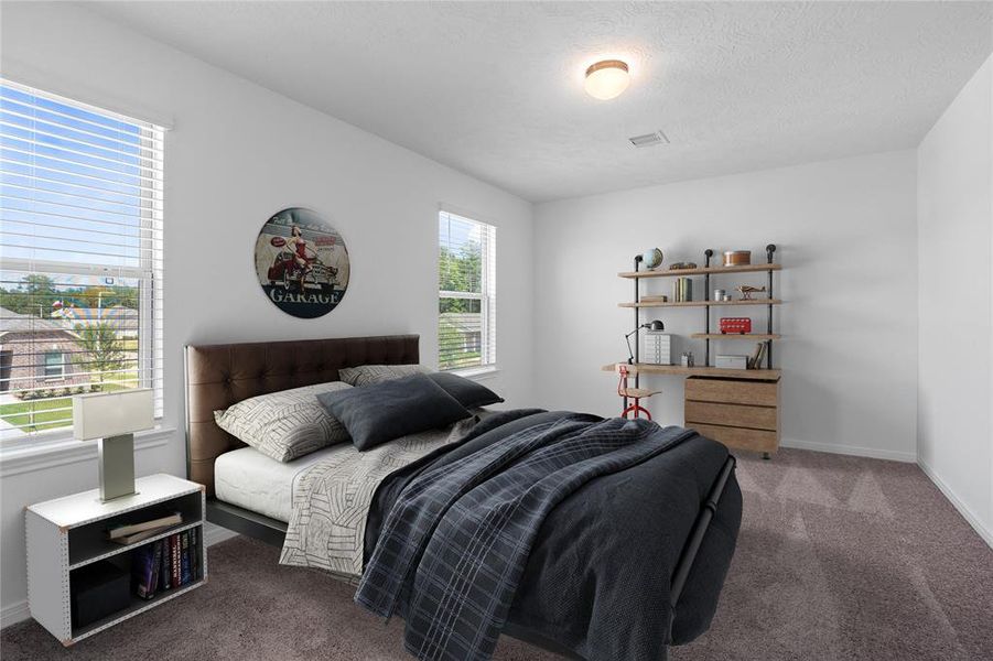 Secondary bedroom features plush carpet, neutral paint, lighting, large window with privacy blinds and ample sized closet space.