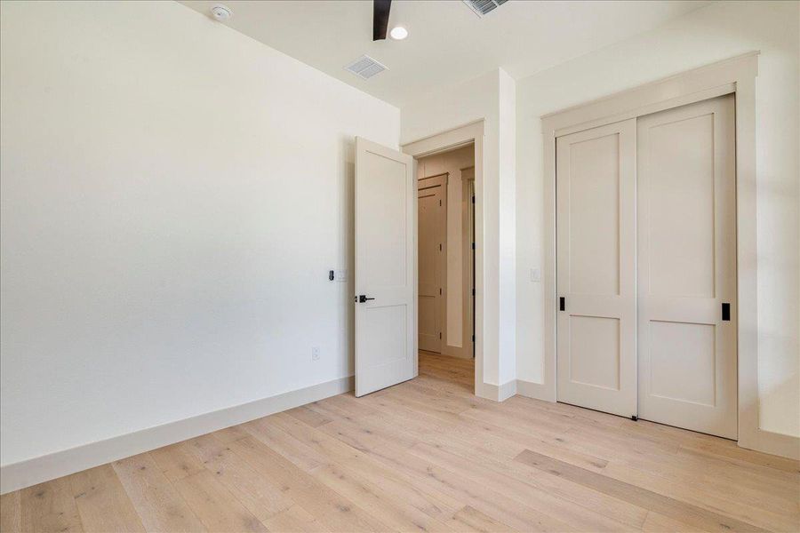 Blonde hardwood flooring and crisp white walls create an airy ambiance in this flexible space.