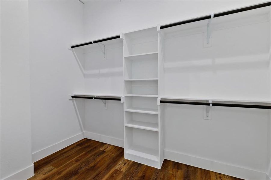 Walk in closet featuring dark wood finished floors