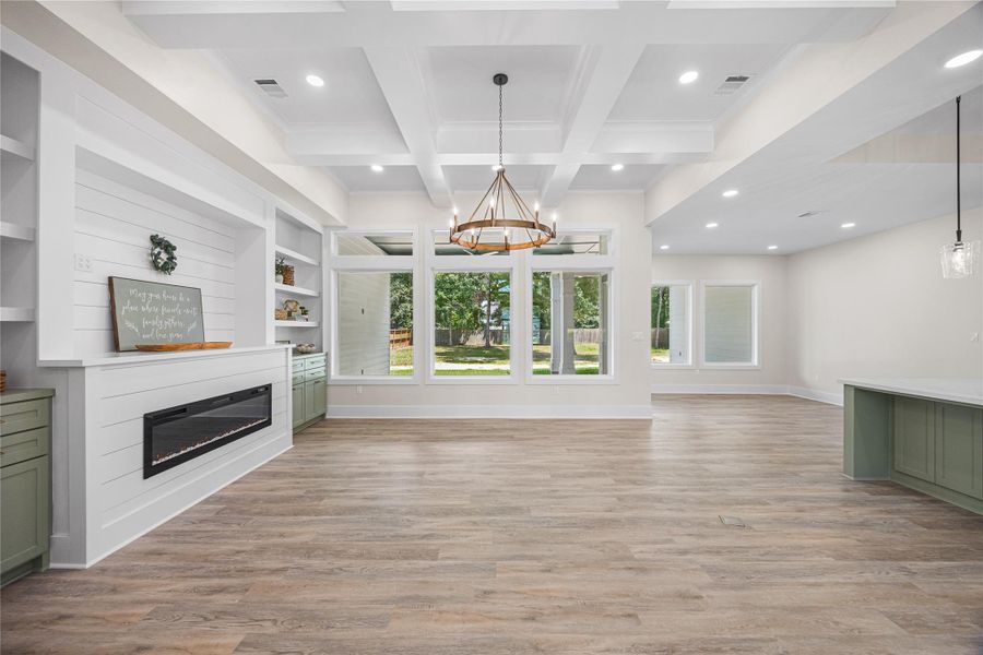 First Thing You See When Walking in are these Stunning Wall of Windows Bringing the Outdoors in Nestled Under a Beautiful Coffer Ceiling.