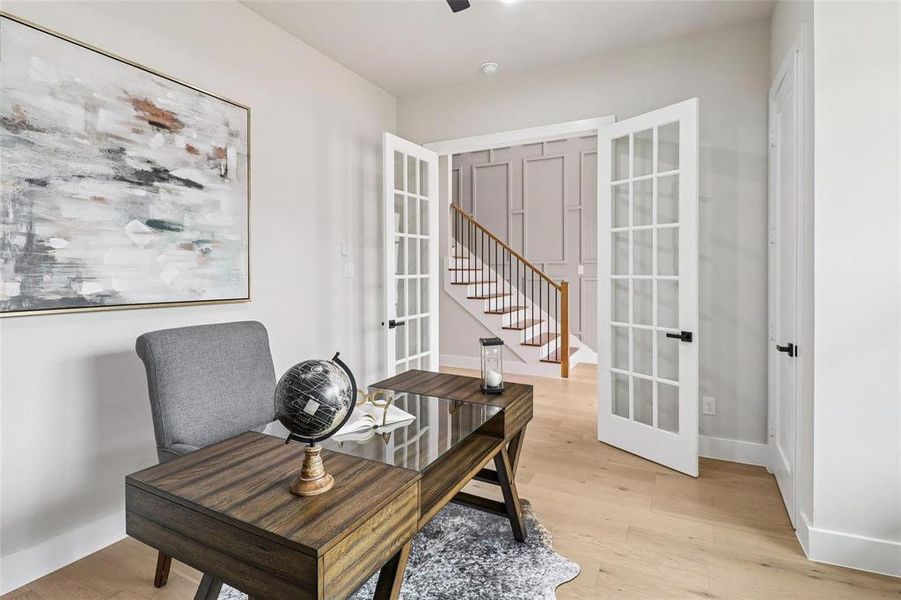 The property features a versatile room with hardwood floors and French doors