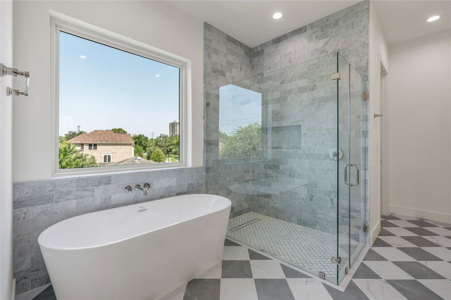 Luxurious primary bath with freestanding tub and walk-in shower.