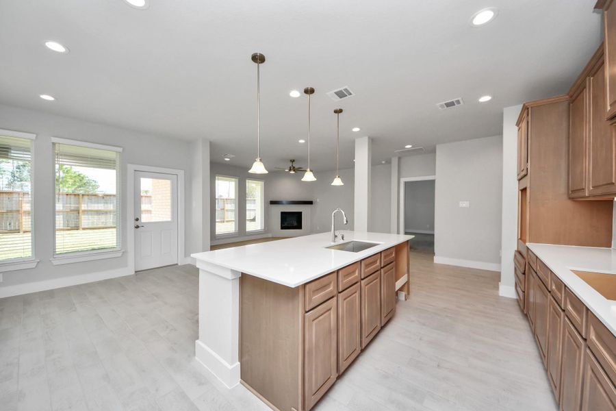 All of this overlooks your expansive family room, creating a perfect space for culinary delights and family gatherings. Sample photo of completed home with similar floor plan. Actual colors and selections may vary. All of this overlooks your expansive family room, creating a perfect space for culinary delights and family gatherings. Sample photo of completed home with similar floor plan. Actual colors and selections may vary.