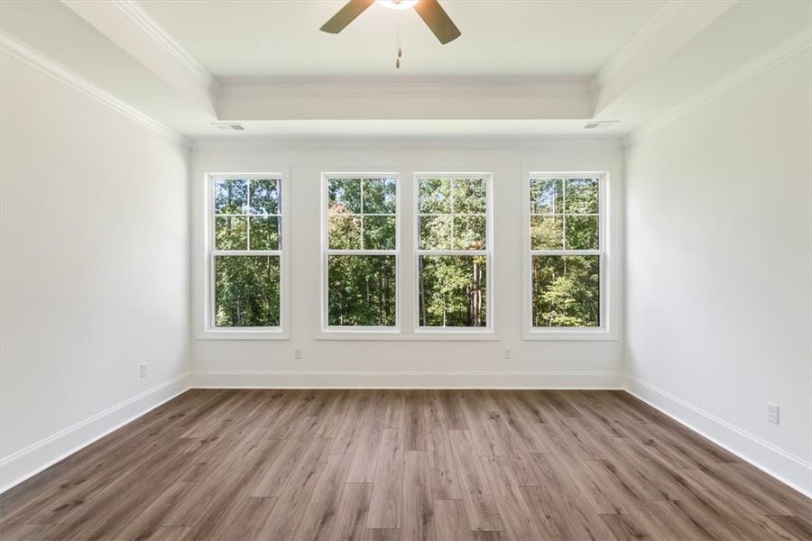 Four large windows fill this wood-floored space wi