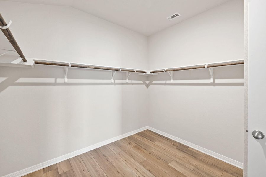 Spacious closet featuring light wood finished floors Spacious closet featuring light wood finished floors
