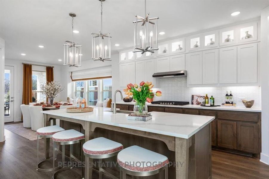 Kitchen with glass insert cabinets, decorative light fixtures, white cabinetry, dark wood-style flooring, and recessed lighting