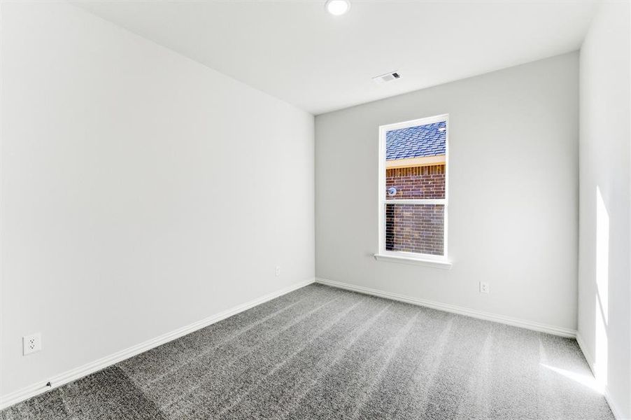 Unfurnished room featuring carpet and baseboards