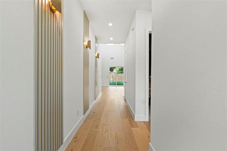 Hall featuring light wood finished floors and recessed lighting