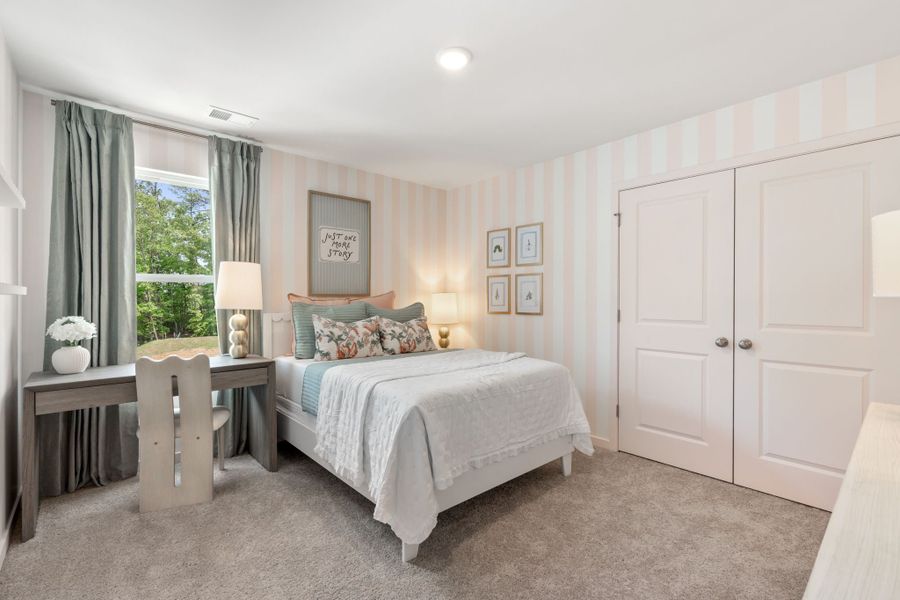 A bedroom with a bed and a desk. A bedroom with a bed and a desk.