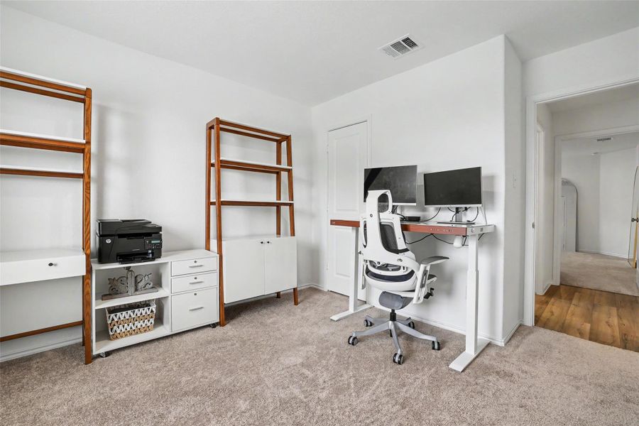 Versatile room featuring light carpeting and white walls