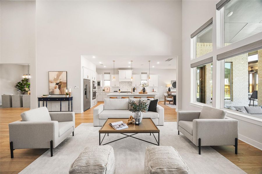 The spacious living room flows seamlessly from the kitchen and overlooks the stunning backyard oasis, creating the perfect space to relax, entertain, and enjoy indoor-outdoor living.