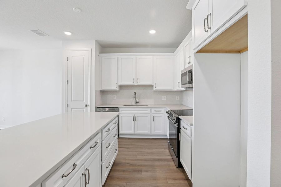 Foyer leads into generous kitchen featuring AW Collection® Timeless