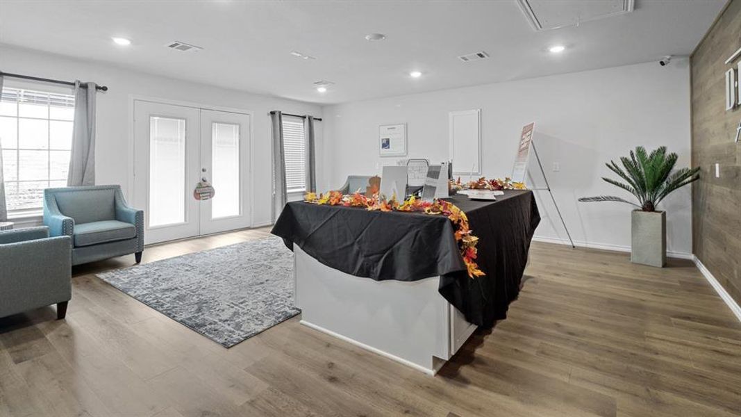 Living area with french doors, light wood-type flooring, and recessed lighting Living area with french doors, light wood-type flooring, and recessed lighting