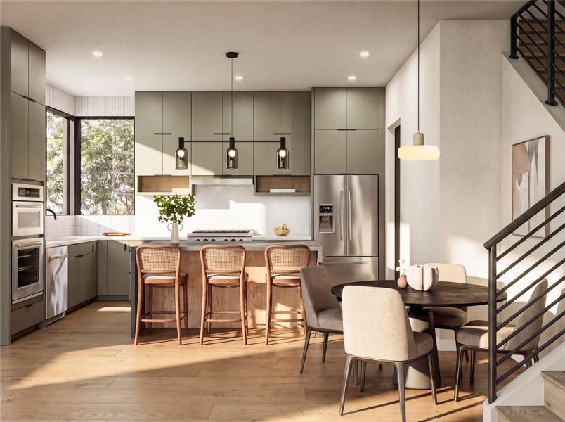 Natural light floods this modern culinary space featuring flat-panel cabinetry and warm hardwood flooring.