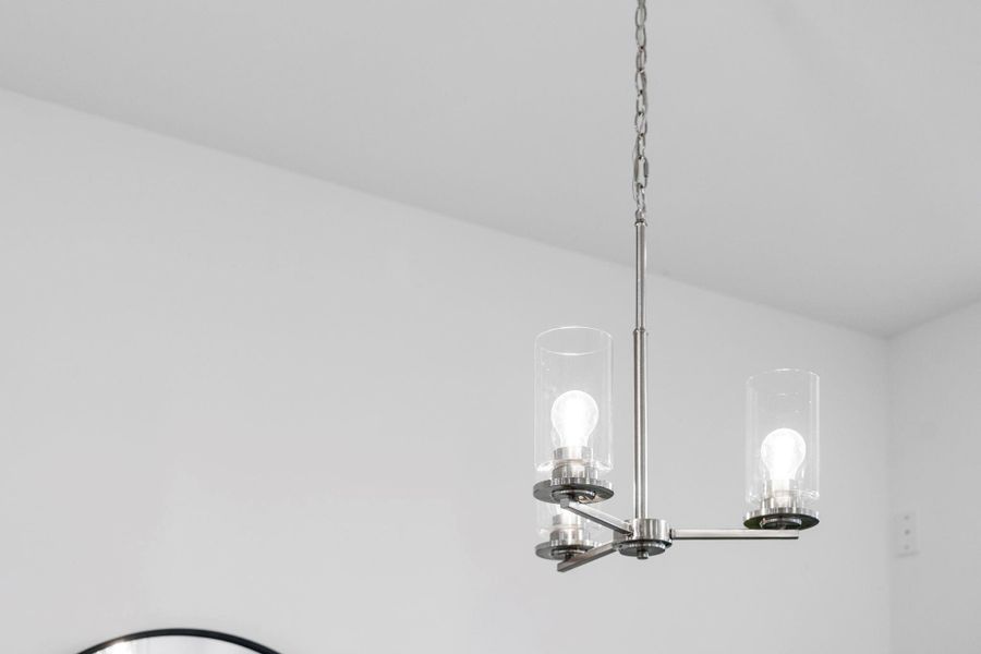 LED chandelier illuminates this modern space with high ceilings