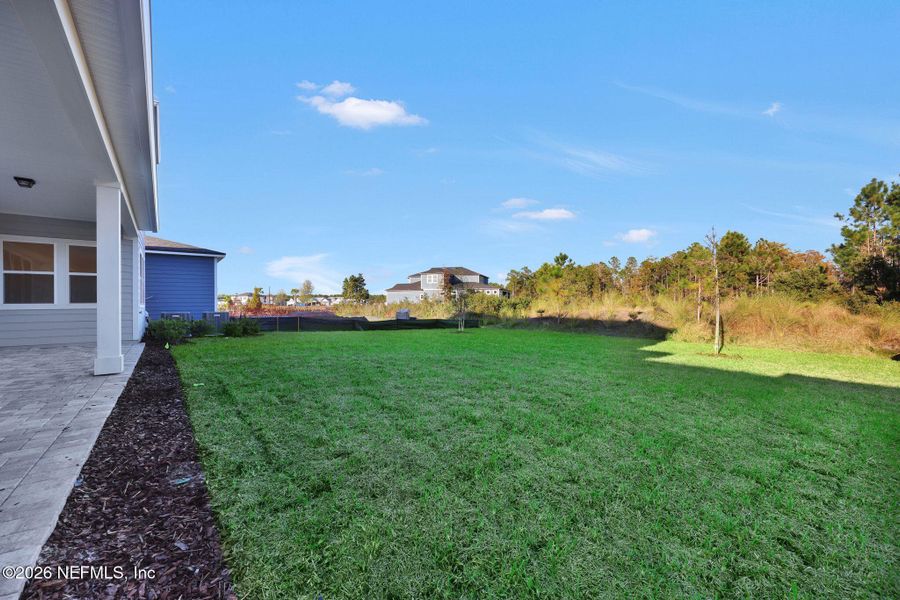 Exterior details and patio area of a home in The Landings at Saint Johns, St. Johns (Image 31).
