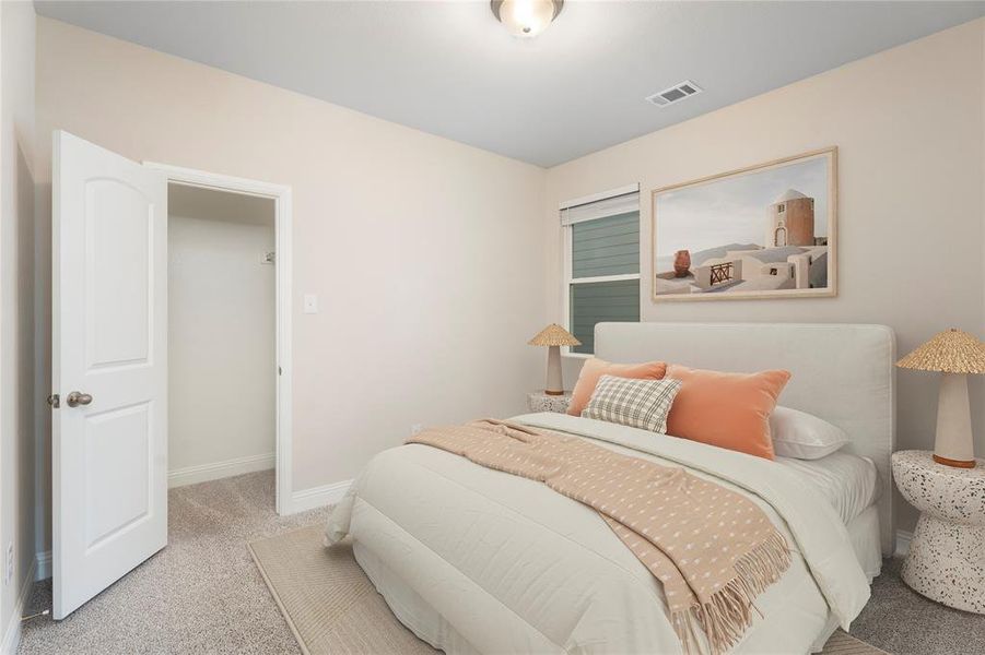 Carpeted bedroom featuring baseboards