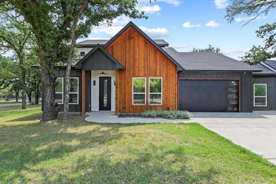 Front exterior of a new home in , Springtown, TX, highlighting curb appeal (Image 1).